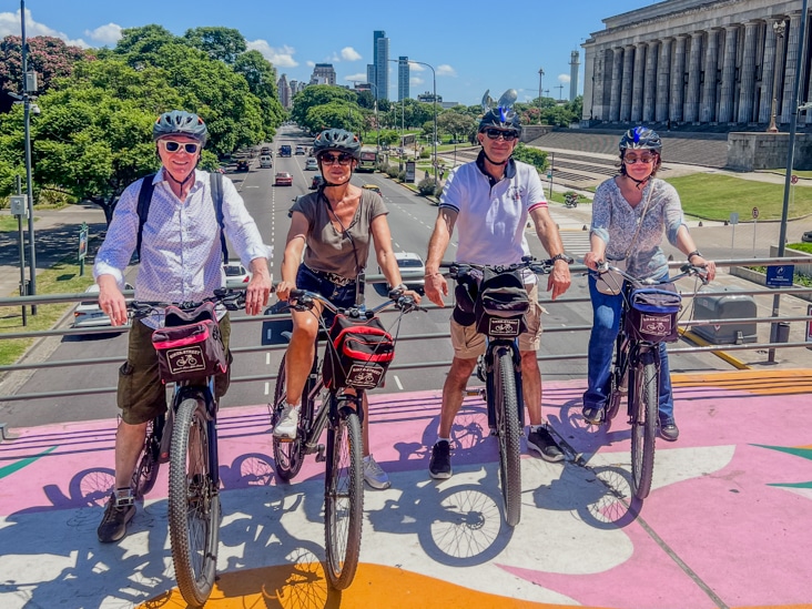 group of people doing a bike tour in Recoleta area on a bridge with a very nice view of Buenos Aires law school