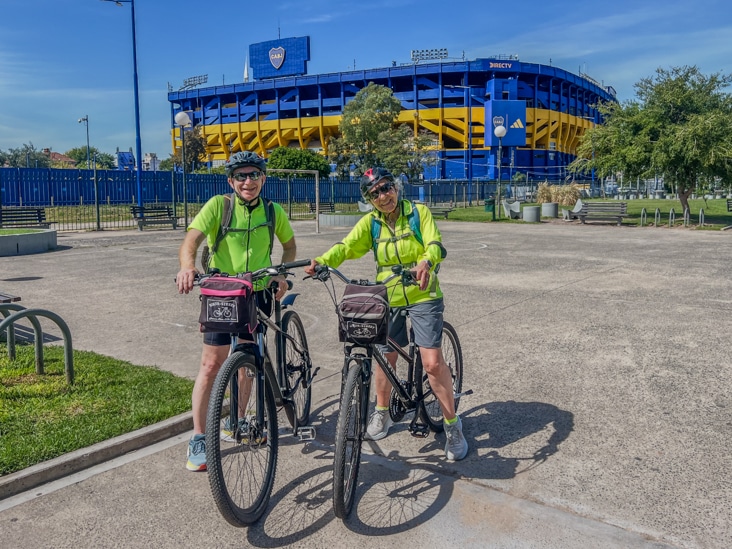 bike tour in la Boca, a couple take a picture with Boca juniors stadium behind them