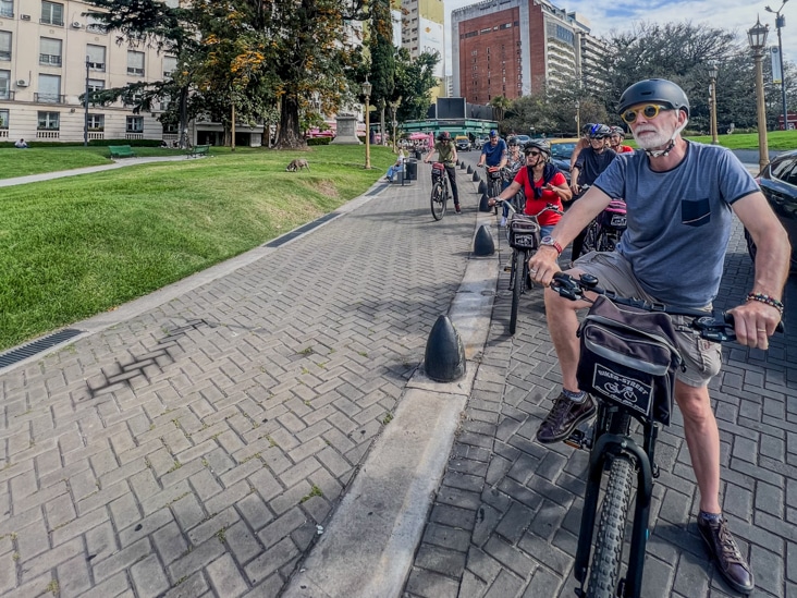 people riding a bike during a bike tour in recoleta area