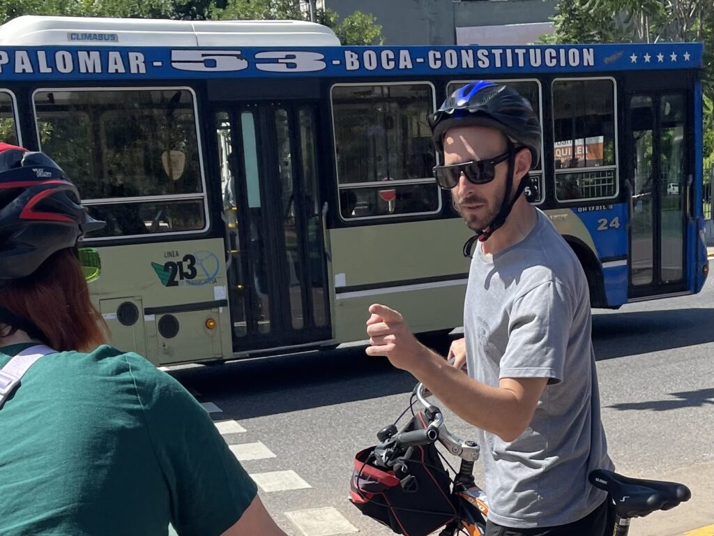 Carlos during a bike tour when a bus is passing in front of him