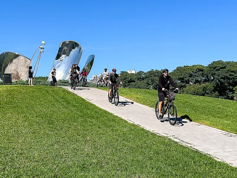 riding bikes next to Floralis Generica