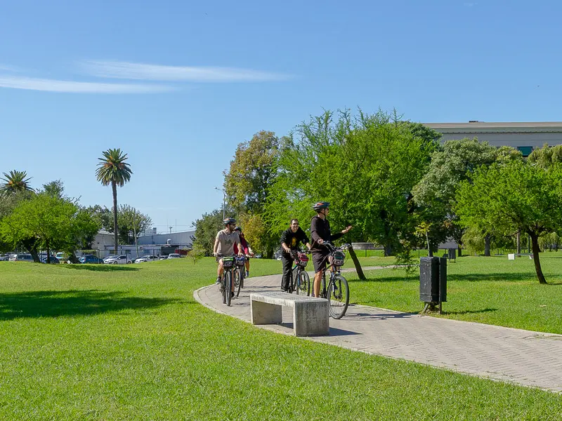 people riding a bike in a city tour in recoleta area