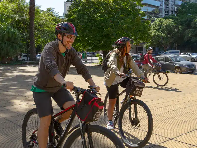 people riding a bike with a biker street city tour